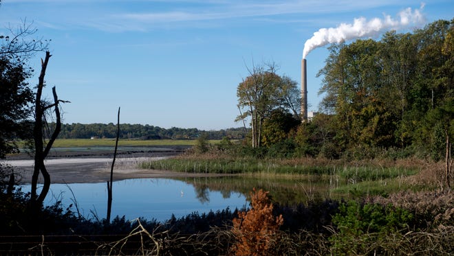 The smokestacks of Vectren's A.B. Brown Generating Station can be seen in the distance behind its coal ash pond in Posey County near Evansville. Vectren has cited the cost of closing the coal ash pond and other environmental updates as reasons for retiring the aging facility. The Indiana Utility Regulatory Commission has rejected Vectren's plan to replace it with a large natural gas-fueled power plant.