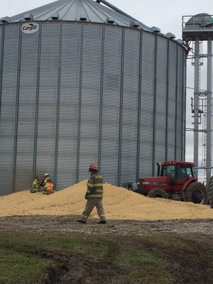 Workers cut a hole in the side of a grain bin in order to rescue a man trapped inside. Similar tragedies could be prevented by following grain handling safety guidelines.