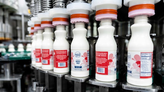 Milk bottles more along a conveyor at Kwik Trip's La Crosse Dairy.