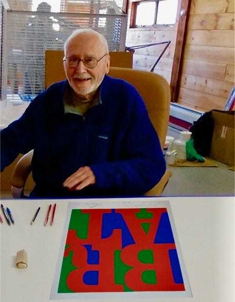 A file photo shows Robert Indiana with a rendering of how the BRAT sculpture will look once it's complete.