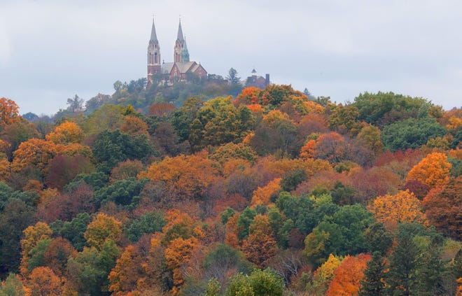 A canopy of fall colored trees surround the Basilica and National Shrine of Mary Help of Christians at Holy Hill as the fall colors start to pop in Hubertus on Oct. 6, 2018.