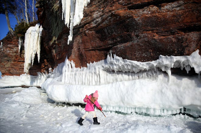 2015. Five-year-old Malila Durand, of Fifield, WI uses a stick to traverse the snow near the Apostle Islands ice caves.
