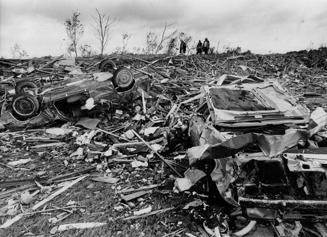 Rescuers walked through rubble left behind in the wake of a killer tornado that roared through Barneveld during the night June 8, 1984.