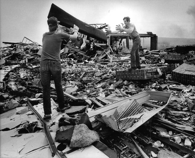 Workers tossed debris from the site of the Barneveld Lutheran Church as recovery efforts continued after a tornado demolished the Iowa County community. President Ronald Reagan declared tornado-stricken Iowa and Dane counties disaster areas.