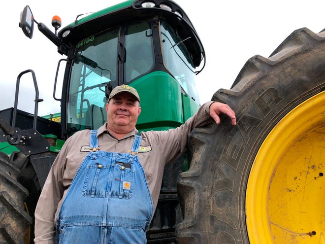 In this Thursday, June 20, 2019, photo, farmer Bernard Peterson leans on a tractor at his farm in Loretto, Ky. When the Trump administration announced a $12 billion aid package for farmers struggling under the financial strain of his trade dispute with China, the payments were capped. But records obtained by The Associated Press under the Freedom of Information Act show that many large farming operations easily found legal ways around the limits to collect big checks. At Peterson's farm, eight members of the family partnership collected a total $863,560 for crops they grow on over 15,000 acres in seven counties, including wheat and corn used at the nearby Maker's Mark bourbon distillery. Peterson said that it didn't make up for all their losses at a time when it was already hard to be profitable. The $1.65 per bushel aid payments for soybeans fell well short of losses he estimated at $2 to $2.50 per bushel, factoring in the loss of the Chinese market that took years to develop.