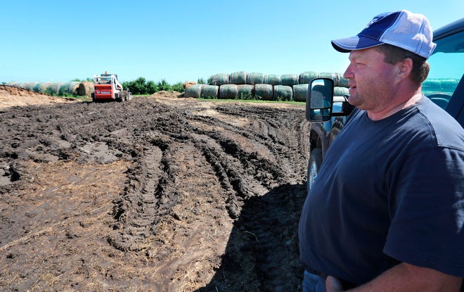 This photo taken July 2, 2019, shows Lannie Mielke talking about the muddy tracks left in the soil by his feeding equipment near a cattle feedlot his farm. Mielke and other area farmers around Aberdeen are having problems with planting and day to day operations due to wet ground caused by spring runoff and rainfall, Mielke said nearly six inches of rain fell on some of his land at the end of June.