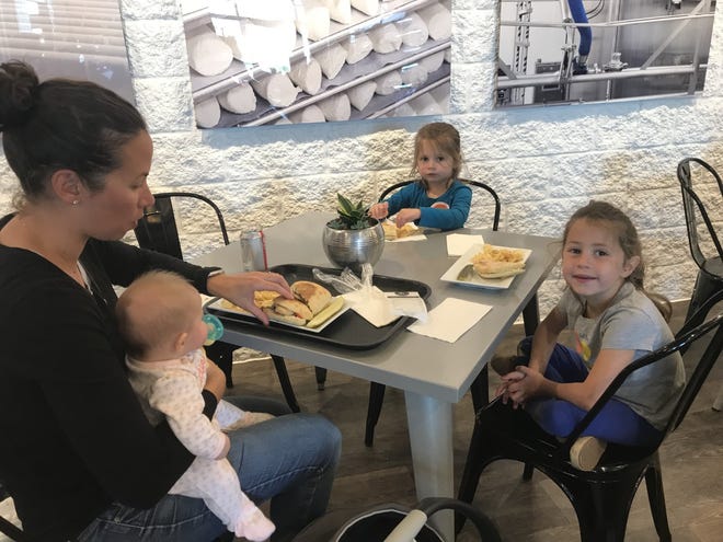 A family enjoys a lunch of grilled goat cheese sandwiches inside the Cheese Shoppe and Cafe which features LaClare and Saxon Artisan
Cheese Products and other specialty items.