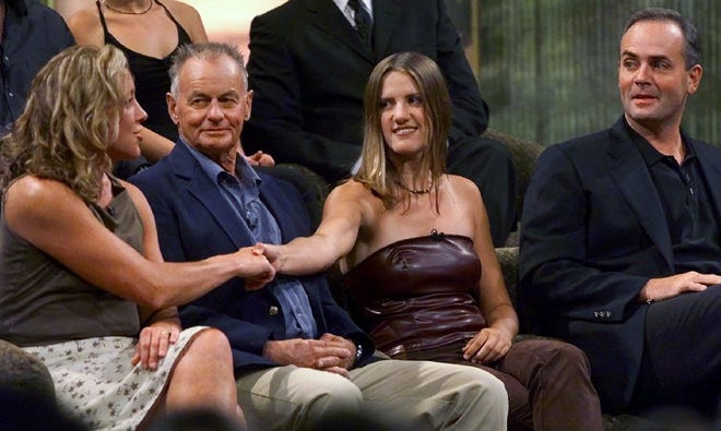 Sue Hawk, left, and Kelly Wiglesworth, second right, shake hands while fellow Survivor contestants Rudy Boesch, second left, and Richard Hatch, right, look on during a live reunion of the first season of "Survivor" on Aug. 23, 2000, at CBS Studios in Hollywood Wednesday. Hawk of Palmyra delivered a final tribal council speech that lives on 20 years later when she compared Wiglesworth to a rat and told her if she was "dying of thirst I would not give you a drink of water. I would let the vultures take you and do whatever they want with you with no ill regrets."