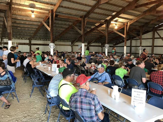 Attendees have conversation over breakfast at the Pepin County Dairy Breakfast held at Four C Dairy in 2018.