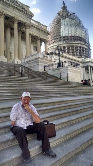 Arden Tewksbury, manager of Pro-Ag sits on the steps of the U.S. Capitol.