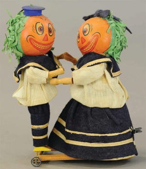 The pumpkin-head dancers are wearing their original blue felt and cotton sailor outfits. They are 8 1/2 inches tall and in excellent working condition, so a collector paid $1,920.