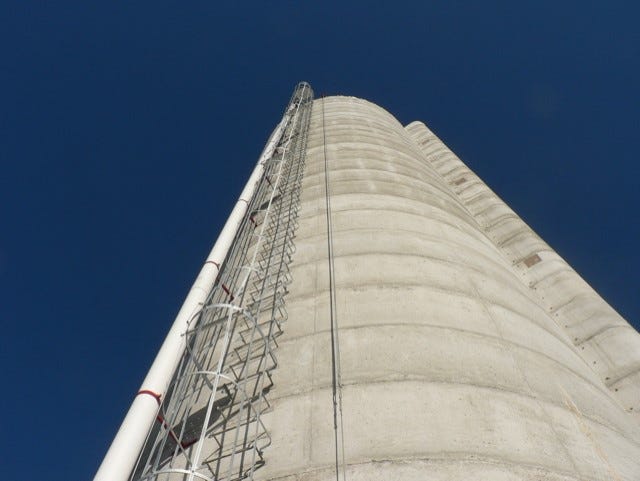 Safety cages now surround the rungs on modern concrete silos.