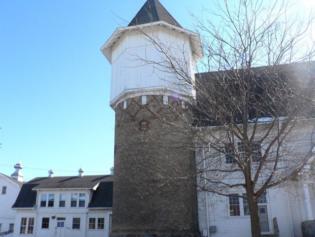 The 18 by 30 foot stone silo with a 14 foot water tank on top has stood next to the old UW-Madison dairy barn for over 125 years
