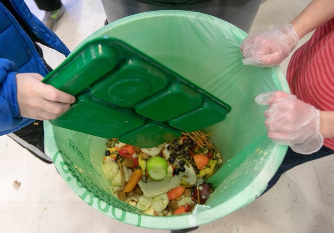 students discard food at the end of their lunch period as part of a lunch waste composting program at an elementary school in Connecticut. A United Nations report released on Thursday, March 4, 2021 estimates 17% of the food produced globally each year is wasted. That amounts to 931 million tons of food, or about double what researchers believed was being wasted a decade ago.