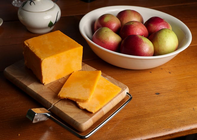 A block of Colby cheese is seen on a cheese slicer. Residents of Colby, Wis., the town for which the cheese is named, have been pushing the state Legislature to designate the cheese as the official state cheese of Wisconsin.