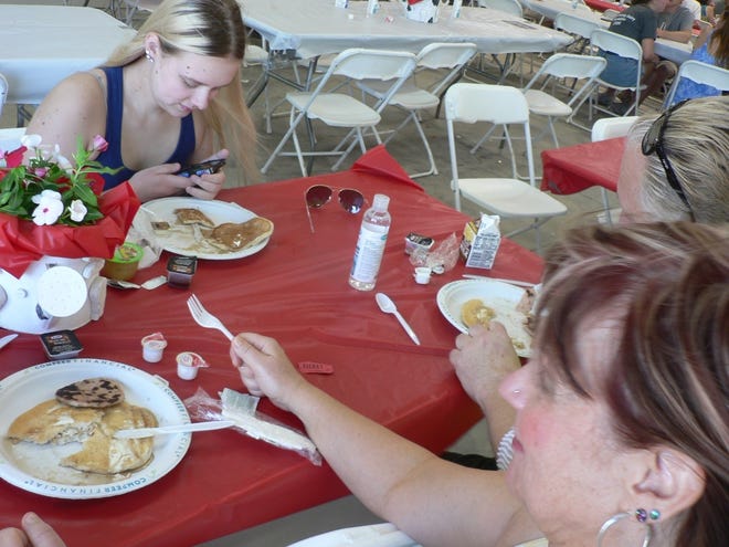Eating breakfast in a tent is not a common event, these visitors from Janesville agreed.
