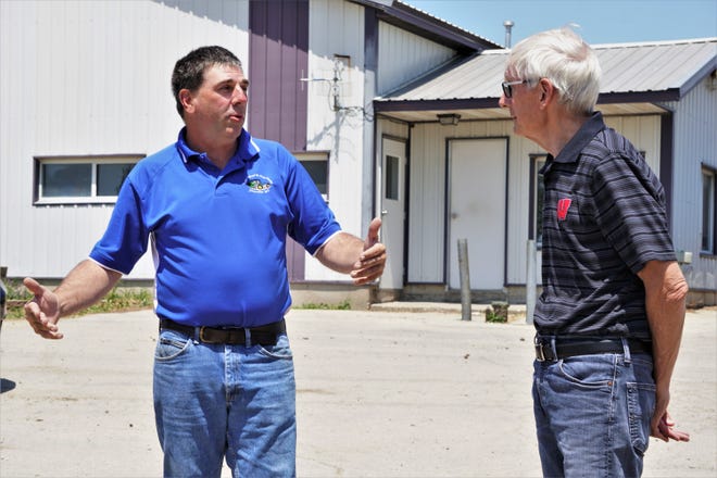 Doug Rebout, partner at Roger Rebout & Sons Farm, talks to Gov. Tony Evers on a tour of the farm June 17, 2021.