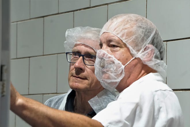 Master cheesemaker Steve Stettler leads Governor Tony Evers on a tour of Decatur Dairy's cheese plant June 17, 2021.