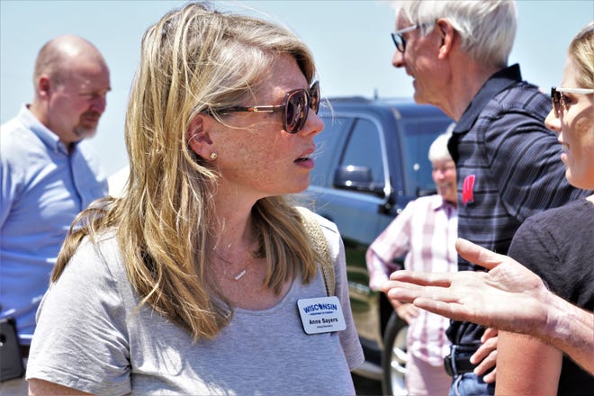 Acting Secretary of the Wisconsin Department of Tourism Anne Sayers talks to farmers at Roger Rebout & Sons Farm near Janesville, Wis., June 17, 2021.
