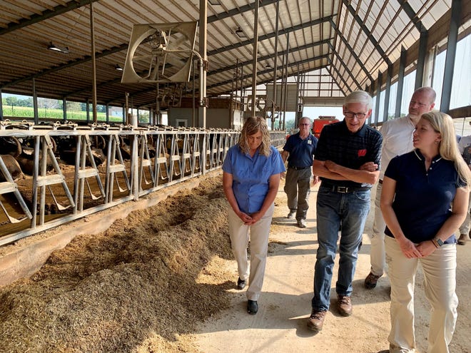 Gov. Tony Evers, center, tours a barn at the Gurn-Z Meadow dairy farm in rural Columbus. on Wednesday, Aug. 18, 2021.