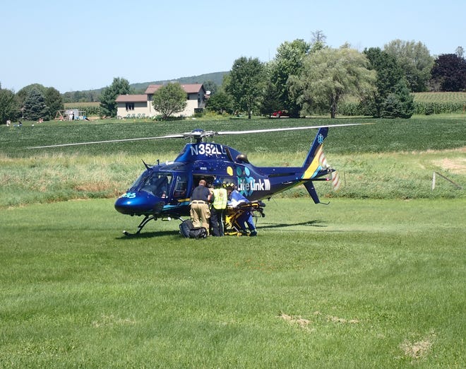 Helicopter ambulance airlifts a patient from a field in this file photo.