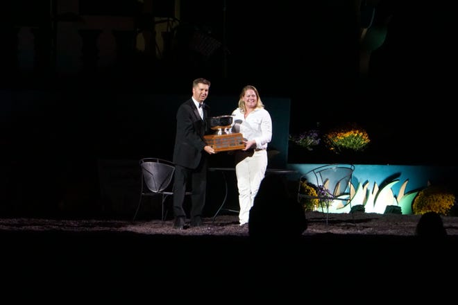 Bill Hageman, president of World Dairy Expo Board of Directors, presents Ysabel Jacobs with the 2021 A.C. "Whitie" Thomson Award.