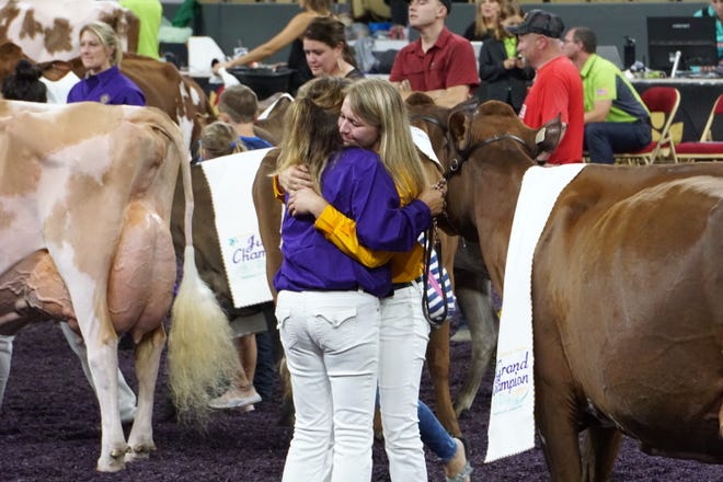 Two exhibitors share a heartfelt moment as the 2021 World Dairy Expo comes to an end.