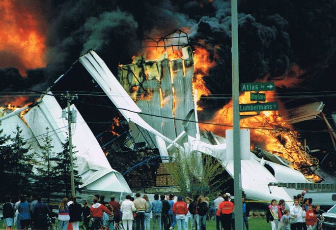 spectators watch as the Central Storage & Warehouse on Cottage Grove Road goes up in flames in May of 1991.