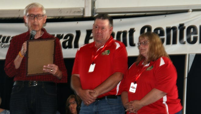Gov. Tony Evers, left, presents an official proclamation to Dennis and Suzie Roehl proclaiming July 12-14 as Farm Technology Days throughout the state of Wisconsin.