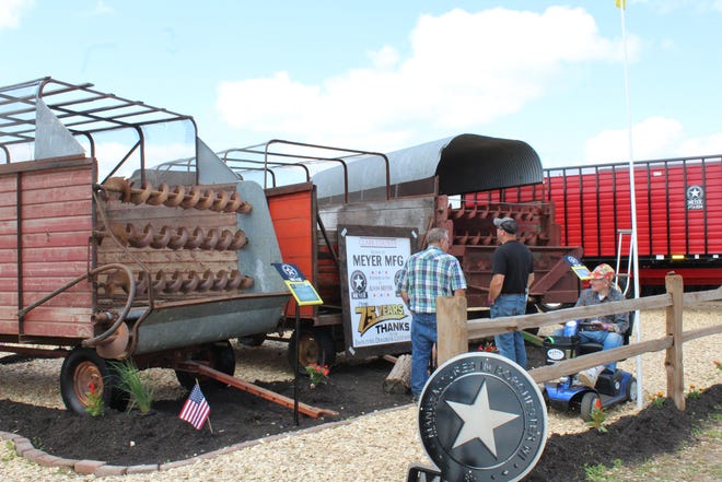 Showgoers check out Meyer Manufacturing Company's display of its products through its 75-year history at Farm Technology Days in Clark County, July 12-14, 2022.