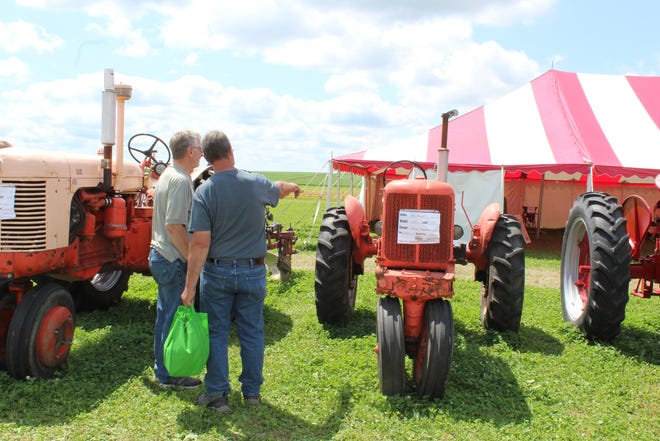 Tractor enthusiasts check out a 1941 Allis Chalmers tractor in the Heritage display at Farm Technology Days in Clark County, July 12-14, 2022.